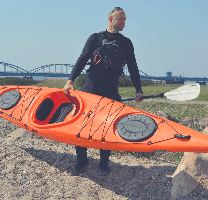 Man with a kayak in his hand.