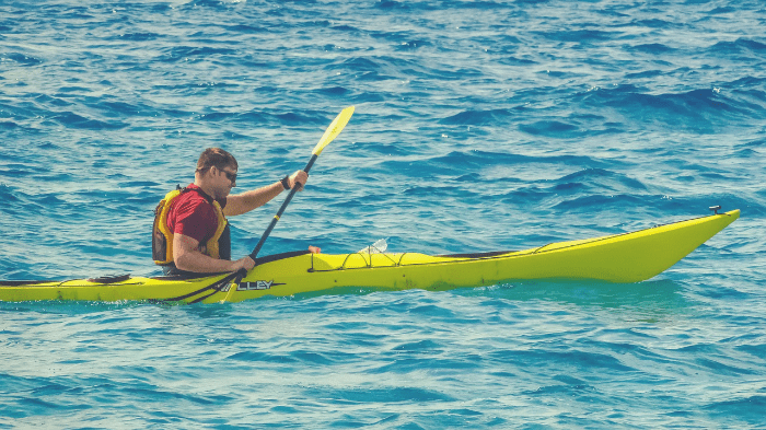Man in a sit-in kayak working on his skills.