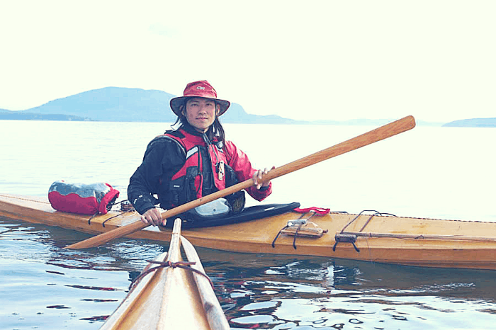 a kayaker with a greenland paddle