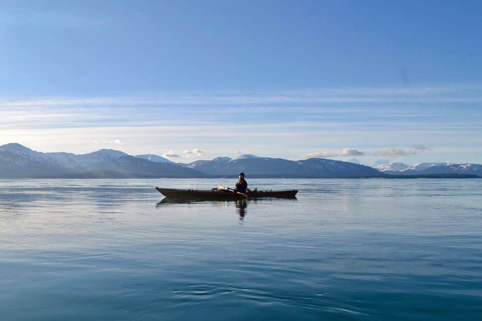 Picture of the author kayaking on a calm lake.