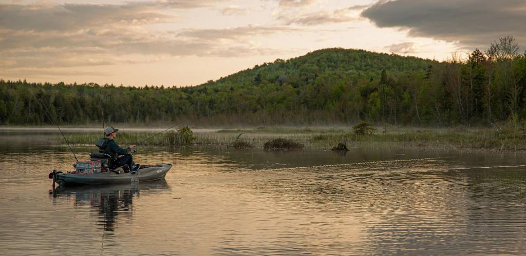 Fishing on a calm lake aboard the Old Town Predator PDL