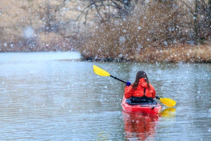 a woman kayaking in the snow