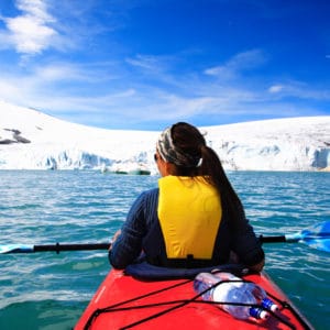 A woman kayaking in the winter cold
