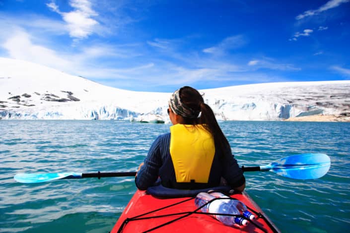 A woman kayaking in the winter cold